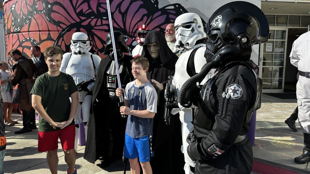 Storm Troopers and other Star Wars characters posing in front of Center for the Arts with young kid fans in downtown Panama City for May thr Fourth Event week on Star Wars day