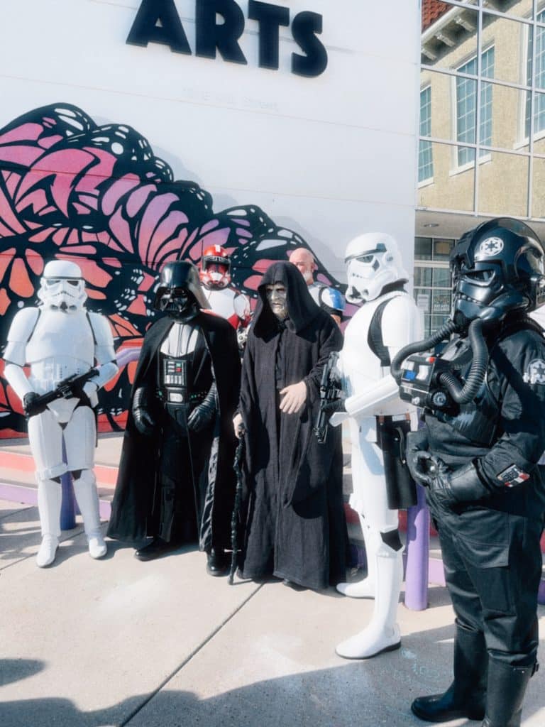 Storm Troopers and other Star Wars characters posing in front of Center for the Arts in downtown Panama City for May the Fourth Event week