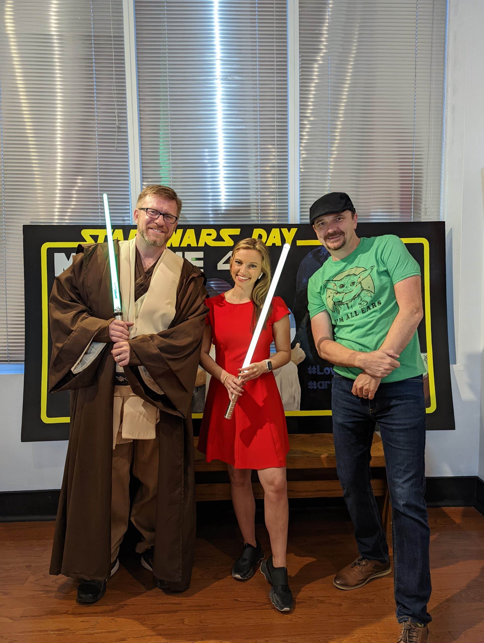Star Wars Day Founder Aaron Rich posed friends holding light sabers on the May the Fourth event week in downtown Panama City