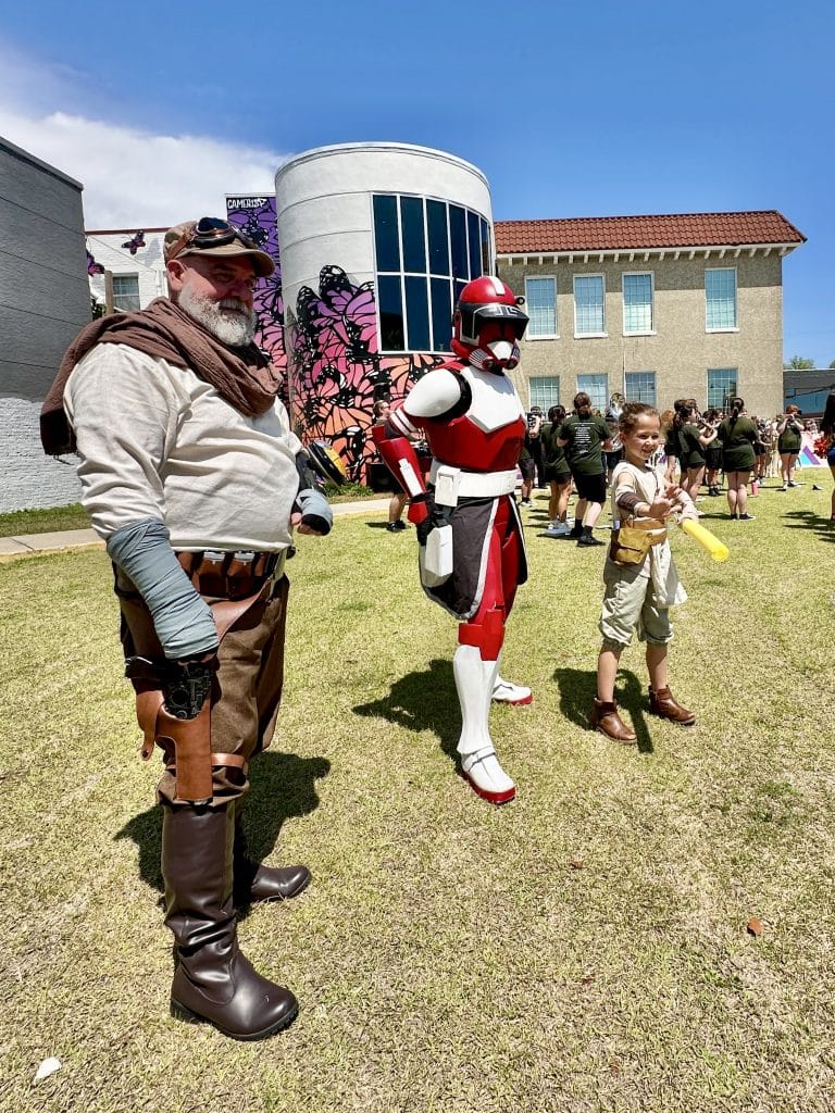 People dressed as Star Wars characters posing for the camera together in front of Center for The Arts Panama City May the 4th event week