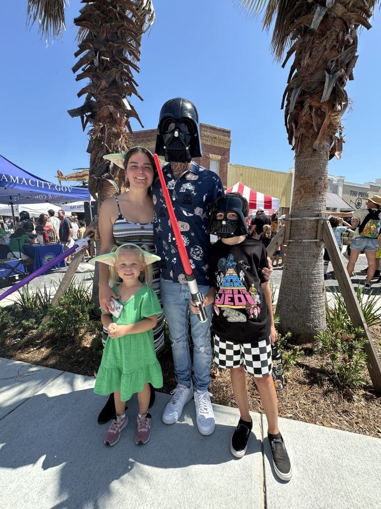 Family dressed in Star Wars fan gear enjoying the downtown Panama City Star Wars event